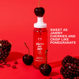 You're My Jam Fragrance Mist - The Body Shop. Bottle against a red background with cherries and pomegranate fruit scattered around the bottle. Overlay text 'Sweet as Jammy Cherries and crisp like pomegranate'.