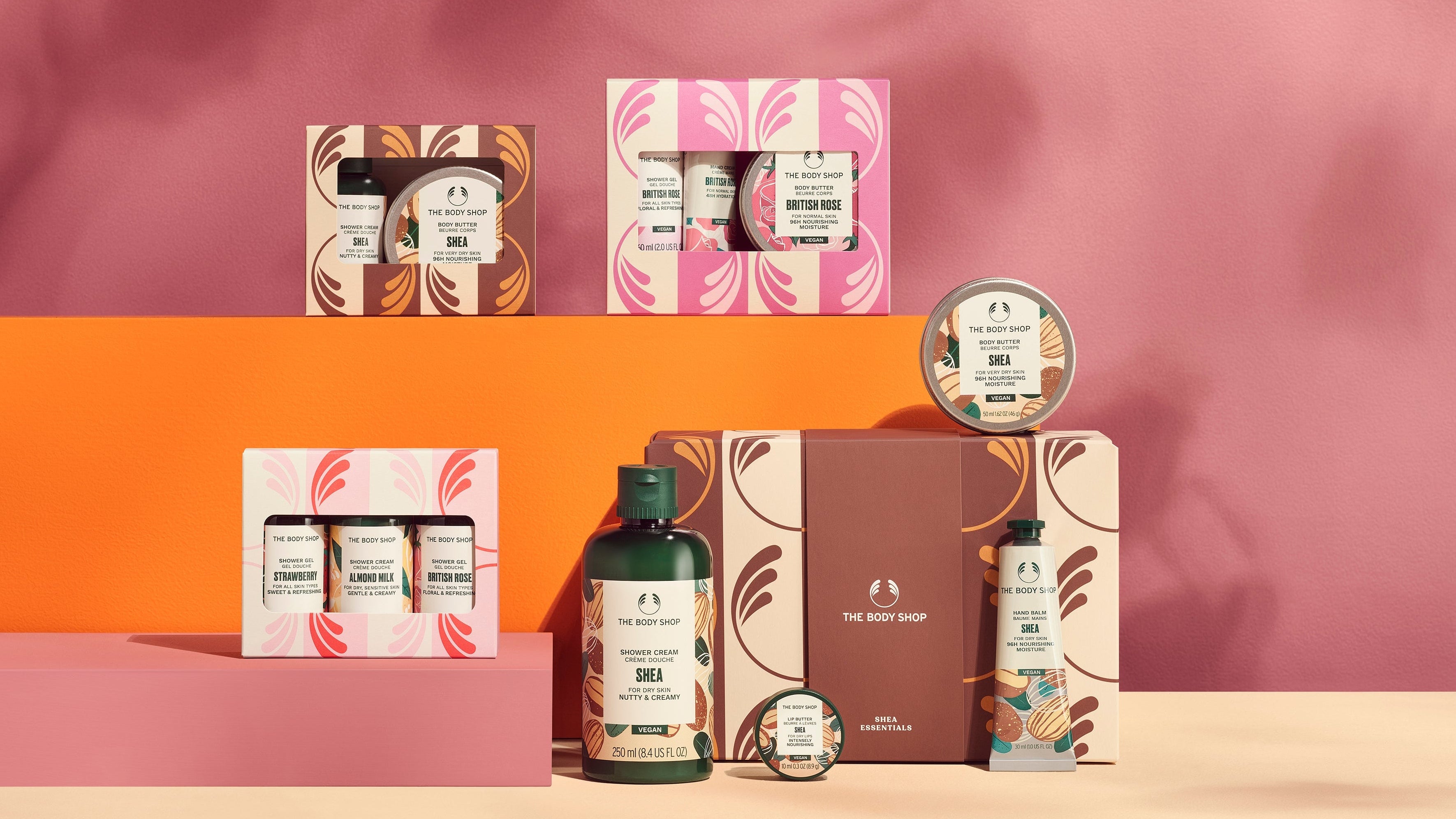 Cosmetic products and packaging on a pink and orange background