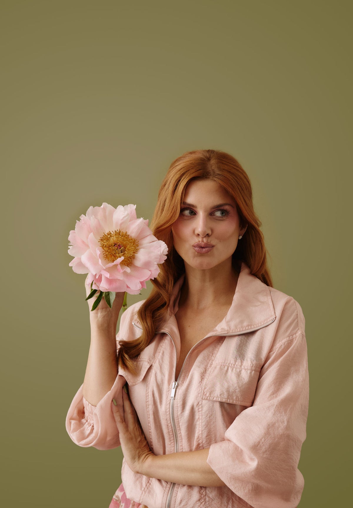 Ashley James holding a wildflower