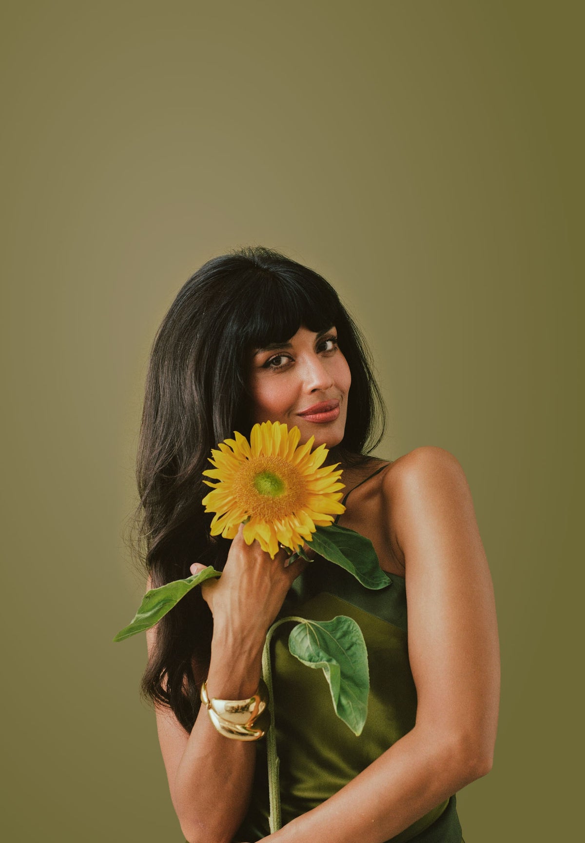Jameela Jamil holding a wildflower