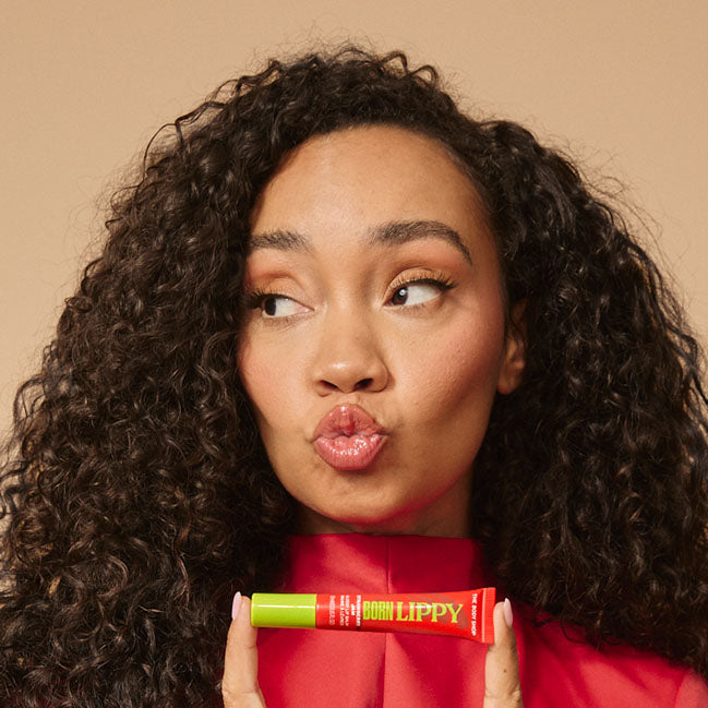 Leigh-Anne Pinnock holding The Body Shop Born Lippy