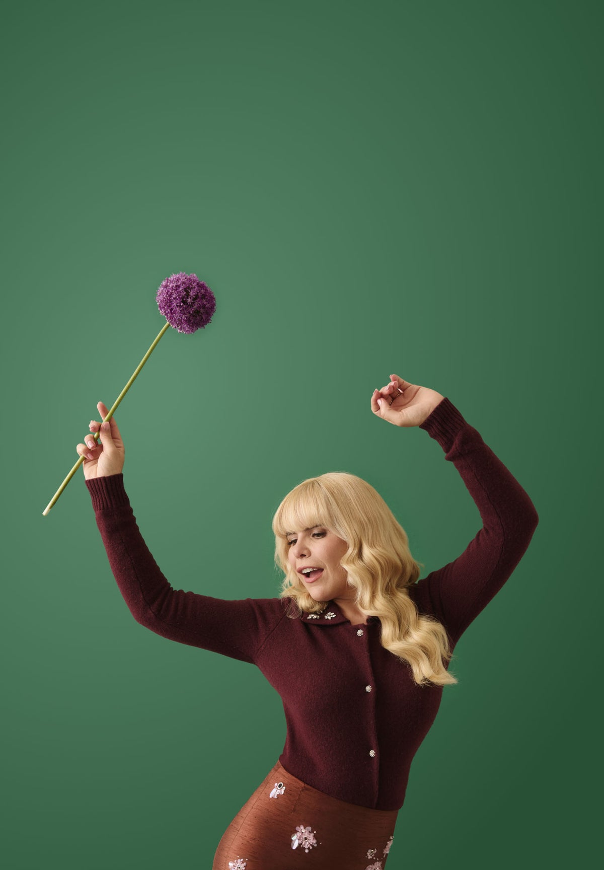 Paloma Faith holding a wildflower